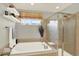 Modern bathroom with a tub, glass shower, stylish tiling and neutral colors at 16367 E Auburn Hills Dr, Parker, CO 80134
