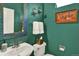 Stylish half bath with a decorative mirror, sink, and elegant wall decor at 16367 E Auburn Hills Dr, Parker, CO 80134