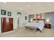 Spacious bedroom with elegant furniture, including a dresser and a bench at 16367 E Auburn Hills Dr, Parker, CO 80134