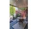 Relaxing covered patio with charming string lights, comfortable seating, and an outdoor grill for entertaining at 16367 E Auburn Hills Dr, Parker, CO 80134