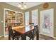 Charming dining room featuring built-in shelving, a wooden table, and natural lighting at 16367 E Auburn Hills Dr, Parker, CO 80134