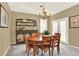 Elegant dining room with a wooden table, classic hutch, and natural light from the backyard at 16367 E Auburn Hills Dr, Parker, CO 80134