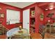 Unique dining room with red walls, wine storage, and a glass table at 16367 E Auburn Hills Dr, Parker, CO 80134