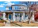 Charming two-story home featuring a welcoming front porch with stone accents and well-maintained landscaping at 16367 E Auburn Hills Dr, Parker, CO 80134