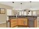 Spacious kitchen area with wooden cabinetry, granite countertops, and stainless steel appliances at 16367 E Auburn Hills Dr, Parker, CO 80134