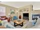 Comfortable living room featuring a fireplace, built-in shelving, and ample seating with stylish decor at 16367 E Auburn Hills Dr, Parker, CO 80134