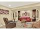 Spacious living room with leather seating, accent tables, and neutral decor at 16367 E Auburn Hills Dr, Parker, CO 80134