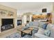 Inviting living room with a fireplace, large sofa, and open access to the kitchen at 16367 E Auburn Hills Dr, Parker, CO 80134