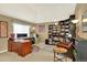 Spacious home office with shelving, large desk, and plenty of natural light at 16367 E Auburn Hills Dr, Parker, CO 80134