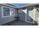 A charming outdoor patio featuring a small table, access door, and large window for natural light and outdoor enjoyment at 16367 E Auburn Hills Dr, Parker, CO 80134