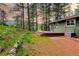 View of home's backyard with green lawn, deck, trees, and landscaping at 5237 S Olive Rd, Evergreen, CO 80439