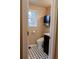 Cozy half bathroom featuring a window, tiled floor, and stylish storage cabinet at 5237 S Olive Rd, Evergreen, CO 80439