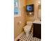 Well-lit half bathroom features a modern bidet and black and white tile at 5237 S Olive Rd, Evergreen, CO 80439