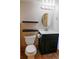 Bathroom with floating shelves, modern vanity, updated mirror, and toilet at 5237 S Olive Rd, Evergreen, CO 80439
