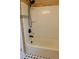 Clean bathroom with white shower-tub combo and modern fixtures at 5237 S Olive Rd, Evergreen, CO 80439