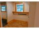 Functional closet space with wood trim window, shelf, and wood-look floors at 5237 S Olive Rd, Evergreen, CO 80439