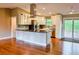 Spacious kitchen with modern stainless steel appliances, a large island, and beautiful hardwood floors at 5237 S Olive Rd, Evergreen, CO 80439