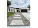 Charming single-story home with a modern walkway, black garage door and beautiful landscaping at 3065 S Birch St, Denver, CO 80222