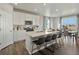 Modern kitchen with island, stainless steel appliances, and white cabinets at 8953 Rifle St, Commerce City, CO 80022