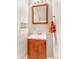 Charming bathroom featuring dark wood vanity, white sink, and bronze fixtures at 2279 Coronado Pkwy # B, Denver, CO 80229