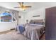Cozy bedroom featuring a ceiling fan, comfortable bed, and view to the outdoors at 2279 Coronado Pkwy # B, Denver, CO 80229