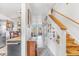 Inviting entryway with a view into kitchen, and stairs with custom built-in shelving at 2279 Coronado Pkwy # B, Denver, CO 80229