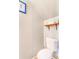 Small toilet room featuring white toilet, and wooden shelf at 2279 Coronado Pkwy # B, Denver, CO 80229