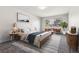 Bright bedroom features soft colors and a large window with a view of mature trees at 695 S Alton Way # 5A, Denver, CO 80247
