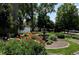Beautifully landscaped garden with colorful flowers, a fountain, and seating at 695 S Alton Way # 5A, Denver, CO 80247