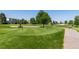 Expansive golf course with lush green fairways, mature trees, and a blue sky providing a serene landscape at 695 S Alton Way # 5A, Denver, CO 80247