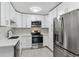 Modern kitchen features stainless steel appliances, white cabinetry and stylish backsplash at 695 S Alton Way # 5A, Denver, CO 80247