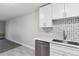 Well-lit kitchen area featuring quartz countertops, stainless steel dishwasher, and modern cabinetry at 695 S Alton Way # 5A, Denver, CO 80247