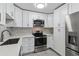 Modern kitchen with stainless steel appliances, stylish backsplash, and ample cabinet space at 695 S Alton Way # 5A, Denver, CO 80247