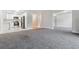 Bright living room featuring neutral carpeting and an open floor plan to the kitchen at 695 S Alton Way # 5A, Denver, CO 80247