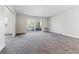 Large living room featuring carpeting and a glass patio door at 695 S Alton Way # 5A, Denver, CO 80247