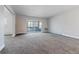 Spacious living room with neutral carpeting and a sliding door to the balcony at 695 S Alton Way # 5A, Denver, CO 80247
