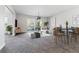 Open living room featuring modern furniture, dining area, and access to the balcony at 695 S Alton Way # 5A, Denver, CO 80247