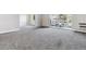 A bright and spacious living room featuring neutral paint and carpeting at 695 S Alton Way # 5A, Denver, CO 80247