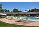 A stunning pool with lounge chairs to relax, with a partial view of the community buildings at 695 S Alton Way # 5A, Denver, CO 80247