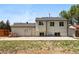 Backyard view with concrete patio, small grass area, and a fence at 5202 Dillon St, Denver, CO 80239