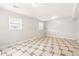 Large open basement space with tile flooring and plenty of natural light at 5202 Dillon St, Denver, CO 80239