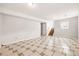 Spacious basement with tile floors and natural light from the stairwell at 5202 Dillon St, Denver, CO 80239
