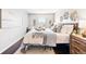 Comfortable bedroom with stylish decor, hardwood floors, and ample natural light at 5202 Dillon St, Denver, CO 80239