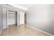 A bright bedroom featuring a closet and tile flooring at 5202 Dillon St, Denver, CO 80239