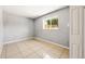 An inviting bedroom featuring tile flooring and ample natural light from the window at 5202 Dillon St, Denver, CO 80239