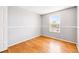 Clean, bright bedroom with hardwood floors and a well-lit window at 5202 Dillon St, Denver, CO 80239