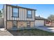 Charming two-story home featuring brick accents, a two-car garage, and a well-maintained front yard at 5202 Dillon St, Denver, CO 80239