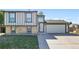 Charming two-story home featuring brick accents, a two-car garage, and a well-maintained front yard at 5202 Dillon St, Denver, CO 80239