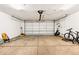An empty garage with door, shelving, and concrete flooring at 5202 Dillon St, Denver, CO 80239