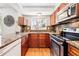 Bright kitchen with granite countertops, stainless steel appliances, and ample cabinet space at 5202 Dillon St, Denver, CO 80239